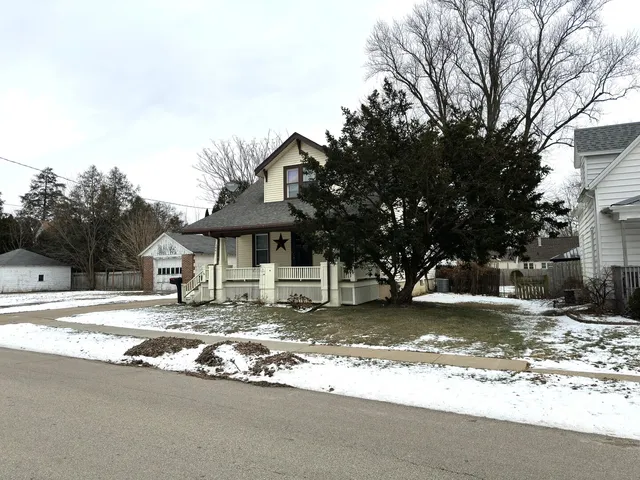 a view of a house with a yard covered in snow
