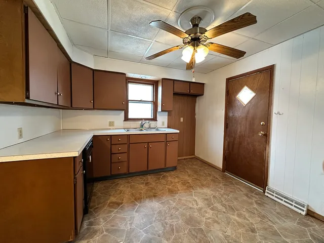 a kitchen with a refrigerator sink and cabinets