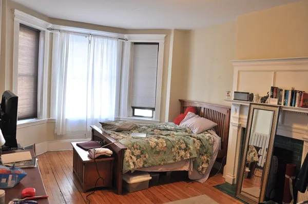 a bedroom with bed and a window