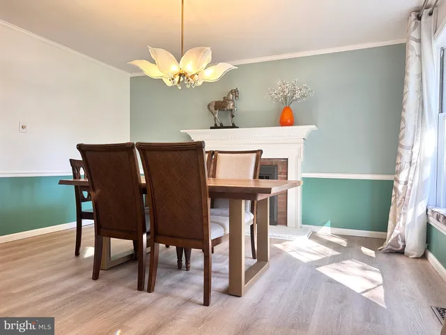 a dining room with furniture and a chandelier