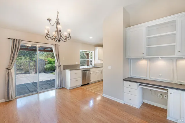 a view of a kitchen with a sink wooden floor and windows