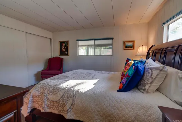 a bedroom with a bed and window