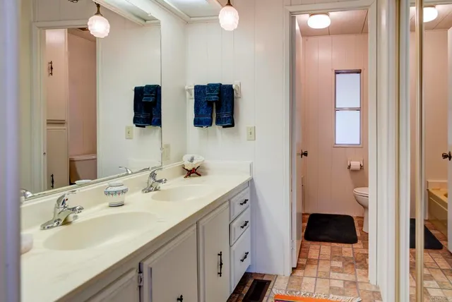 a bathroom with a double vanity sink and mirror