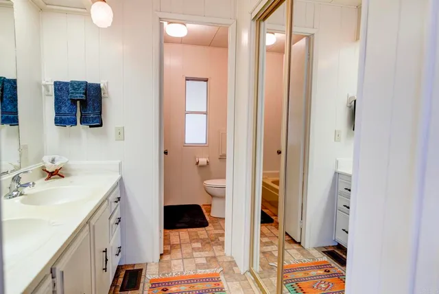 a spacious bathroom with a sink and a mirror