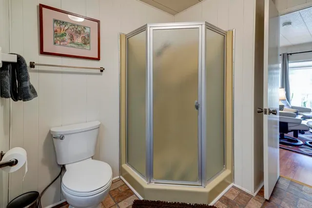 a white toilet sitting next to a bathroom sink