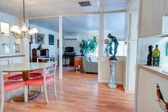 a dining room with furniture and wooden floor