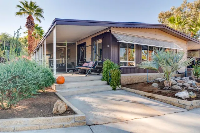 a front view of a house with sitting area