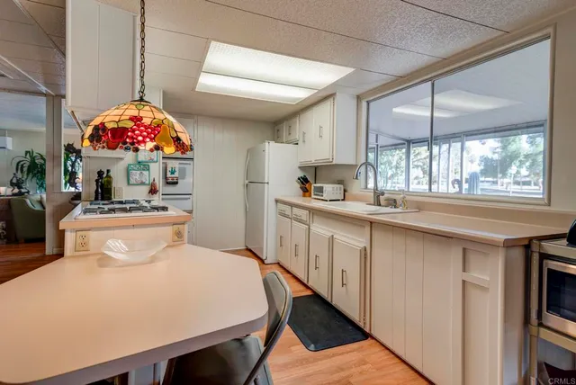 a very nice looking room with a large window and chandelier