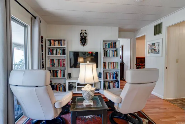 a work room with furniture and a book shelf