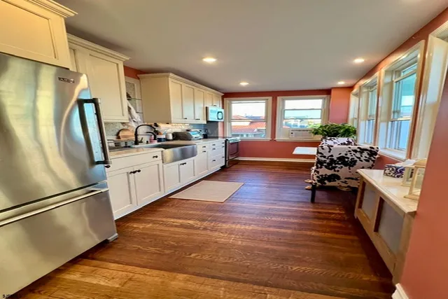 a kitchen with sink refrigerator and window