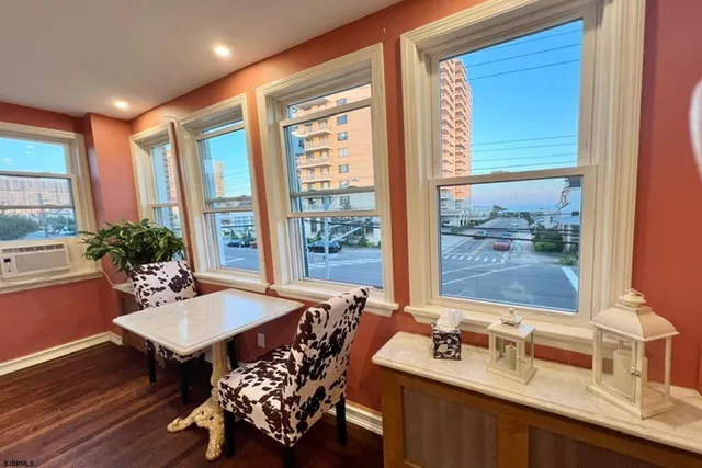 a view of a workspace with furniture and window