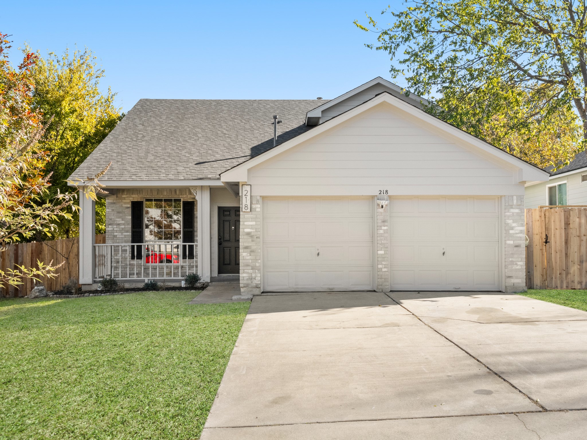 a view of a house with a yard and pathway