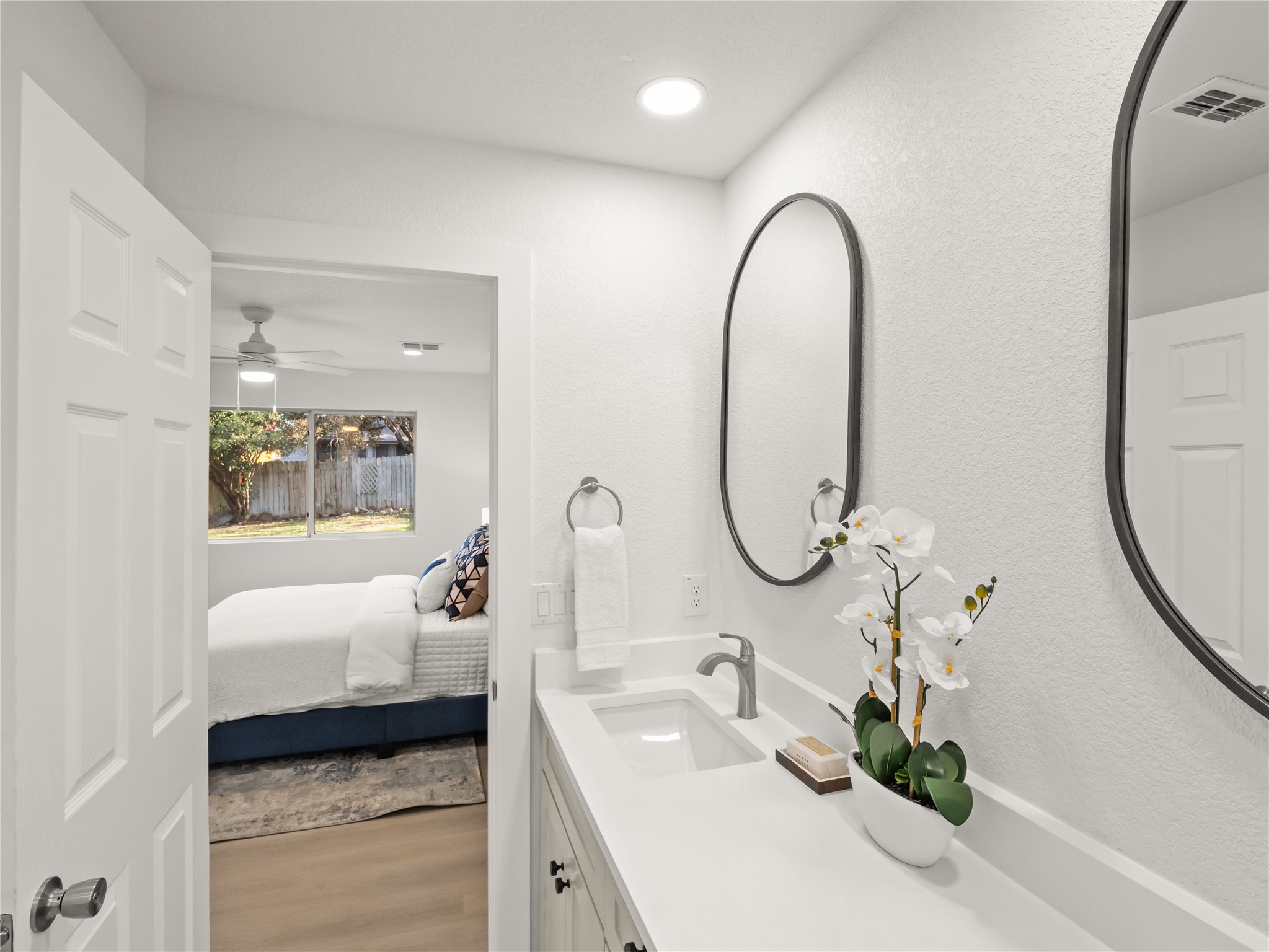 218 Crystal Knoll Boulevard Georgetown, TX 78626 - Photo 16 of 27 Bathroom featuring vanity, light wood-style flooring, ensuite bath, and a ceiling fan