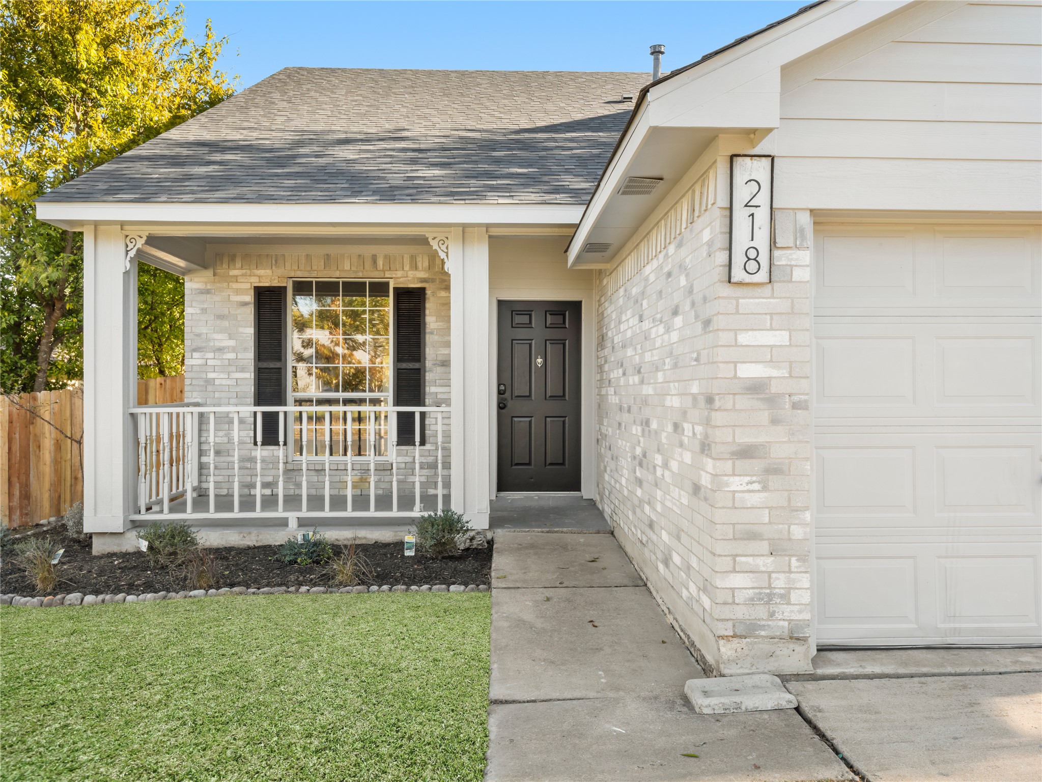 218 Crystal Knoll Boulevard Georgetown, TX 78626 - Photo 2 of 27 Doorway to property featuring brick siding, covered porch, a shingled roof, and an attached garage