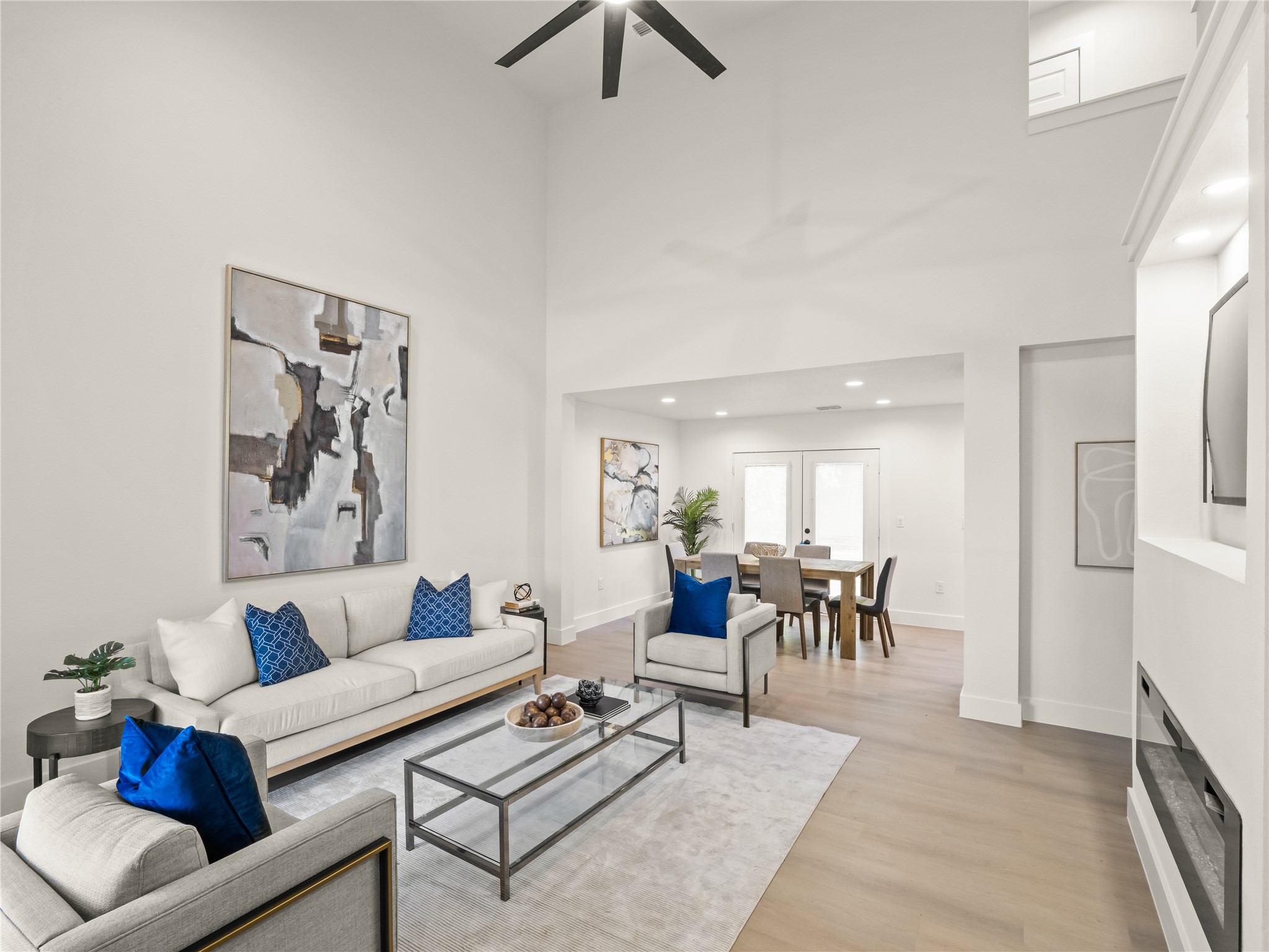 218 Crystal Knoll Boulevard Georgetown, TX 78626 - Photo 6 of 27 Living room featuring a high ceiling, light wood-style floors, a fireplace, and a ceiling fan
