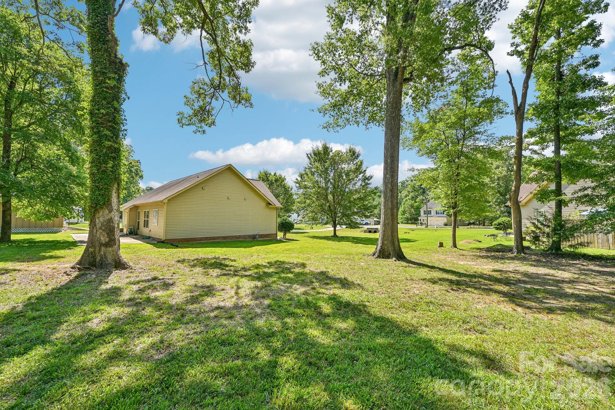 624 Hunley Street Monroe, NC 28112 - Photo 30 of 36 a backyard of a house with lots of green space and fountain in the back