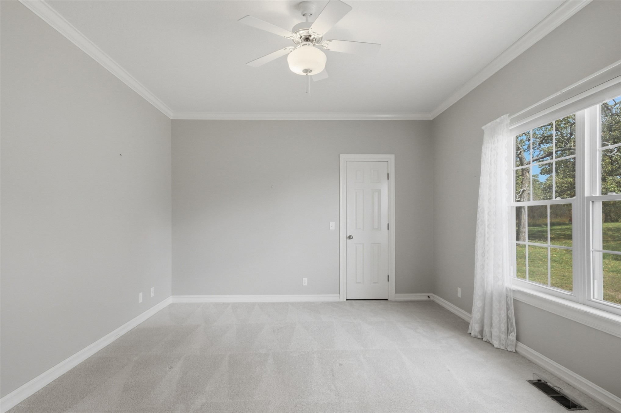 17875 East 589 Road Inola, OK 74036 - Photo 26 of 73 Spacious room featuring light gray carpet, crown molding, a ceiling fan with integrated lighting, and a large multi-pane window, walk in closet and Jack and Jill bathroom