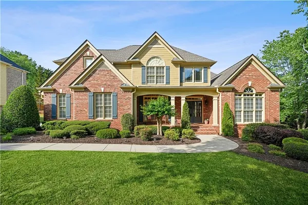 a front view of a house with a yard