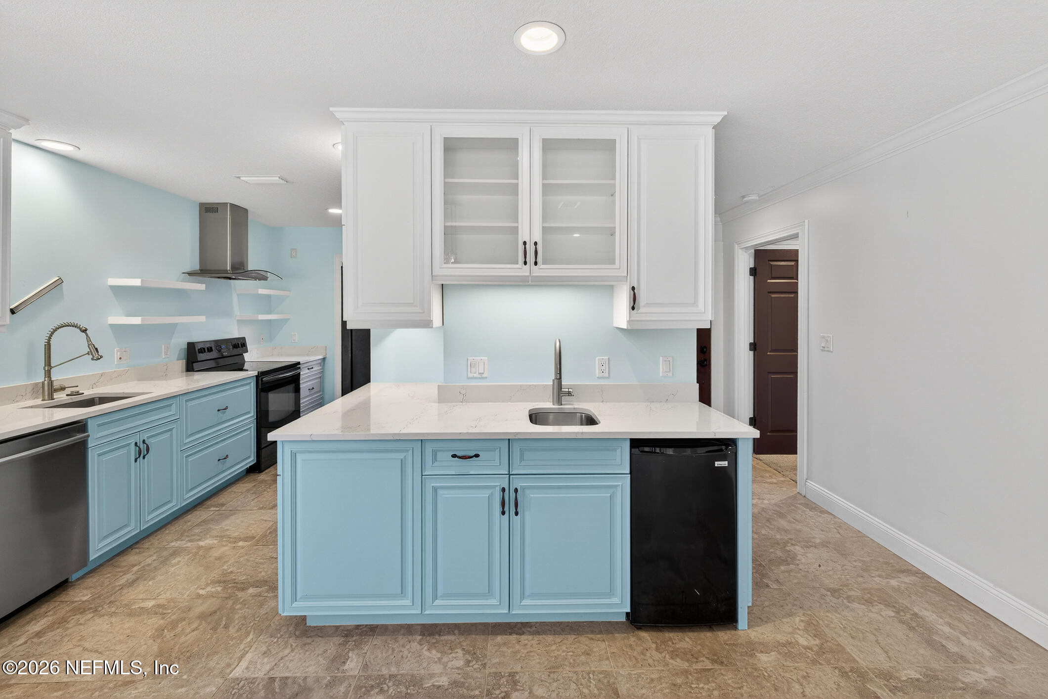 3301 Sea Marsh Road Fernandina Beach, FL 32034 - Photo 13 of 41 a kitchen with a sink and cabinets