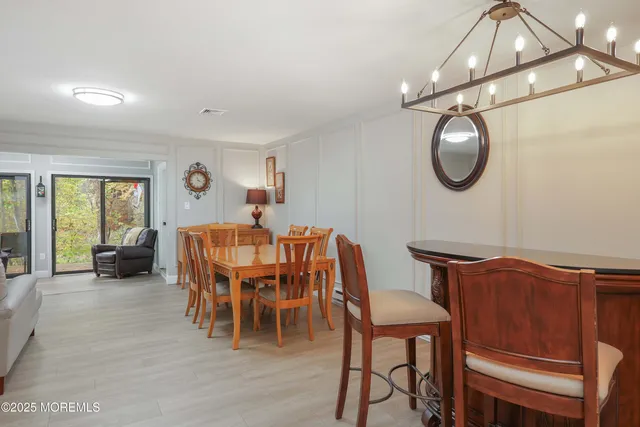 a view of a dining room with furniture and chandelier