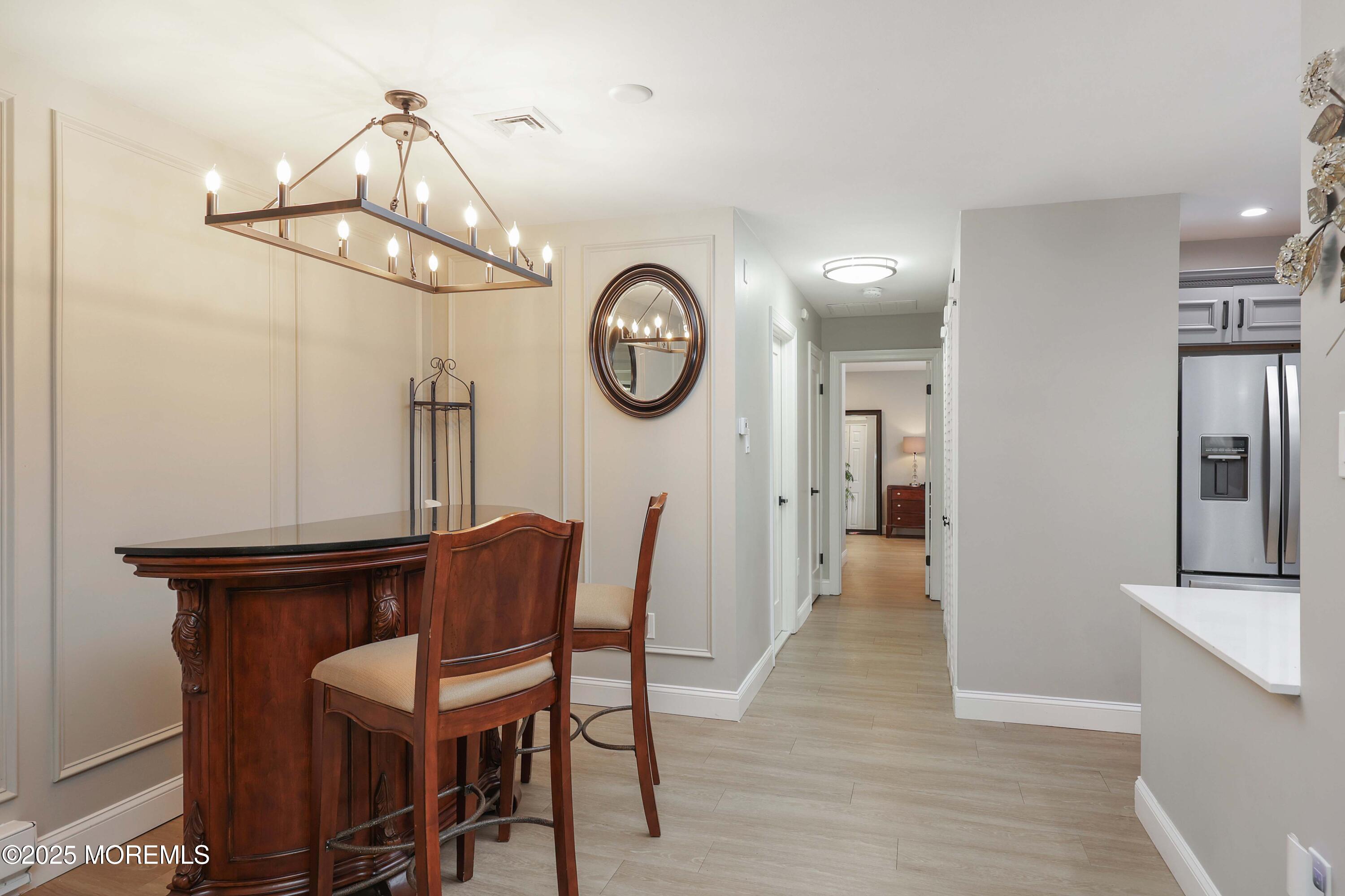 40 Ellsworth Court Red Bank, NJ 07701 - Photo 13 of 30 a view of a dining room with furniture a chandelier and wooden floor