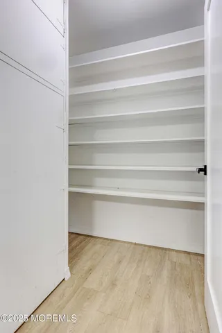 a patio with table and chairs and potted plants