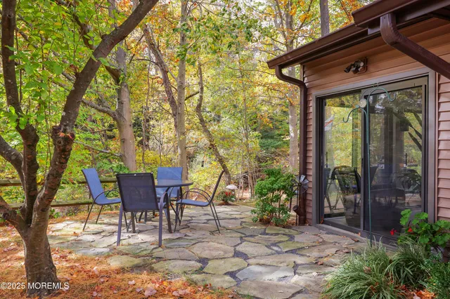 a view of a patio with table and chairs and wooden floor