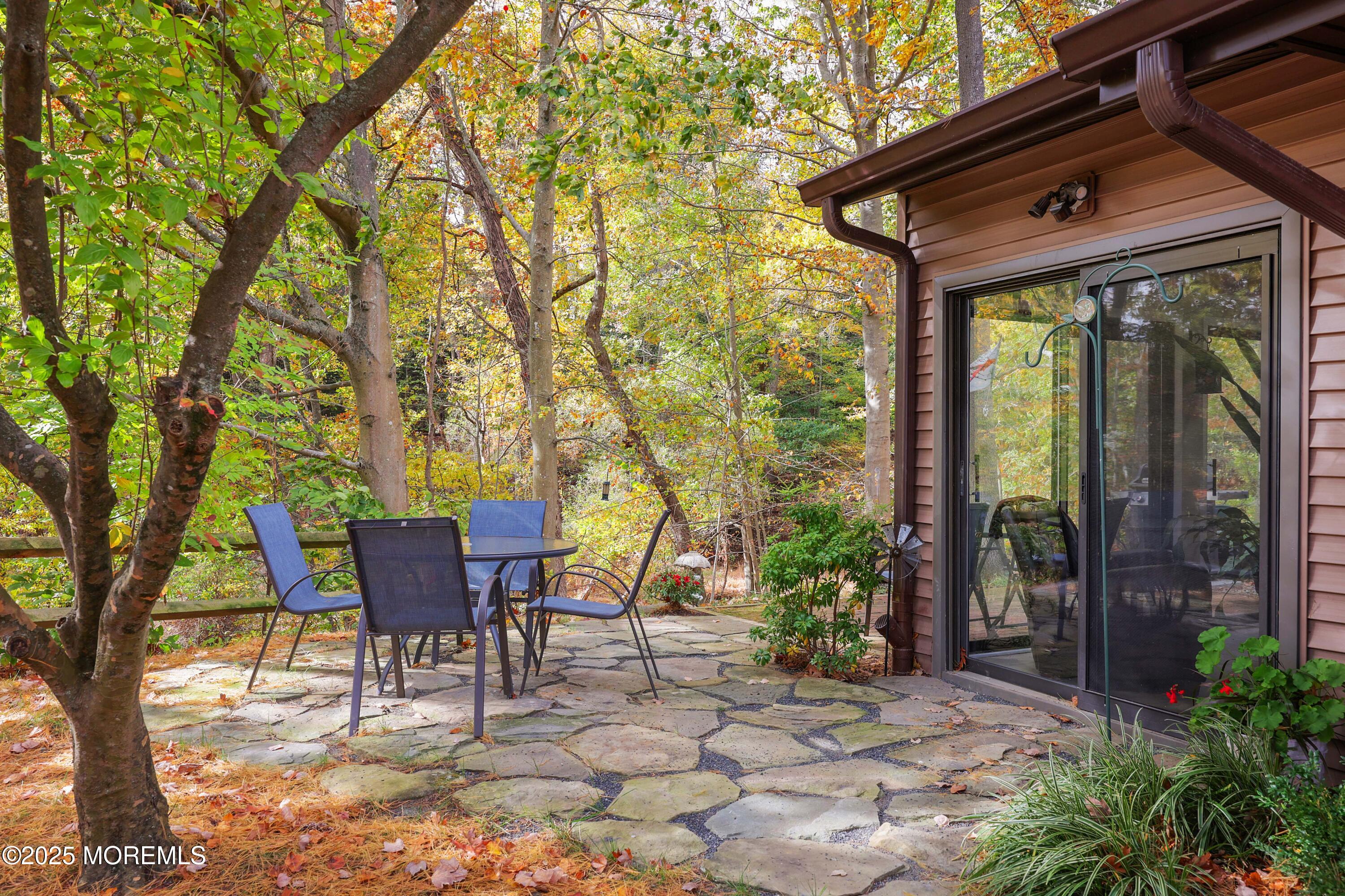 40 Ellsworth Court Red Bank, NJ 07701 - Photo 24 of 30 a patio with table and chairs and potted plants
