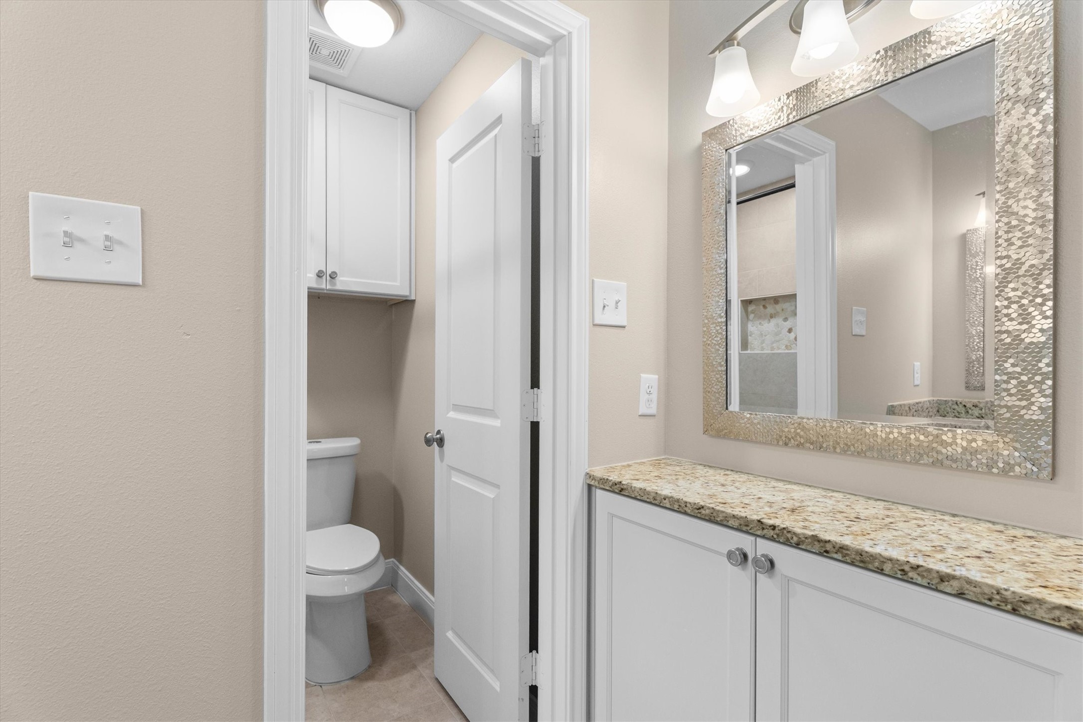6530 Bayonne Drive Spring, TX 77389 - Photo 30 of 37 a bathroom with a granite countertop sink a toilet and a mirror