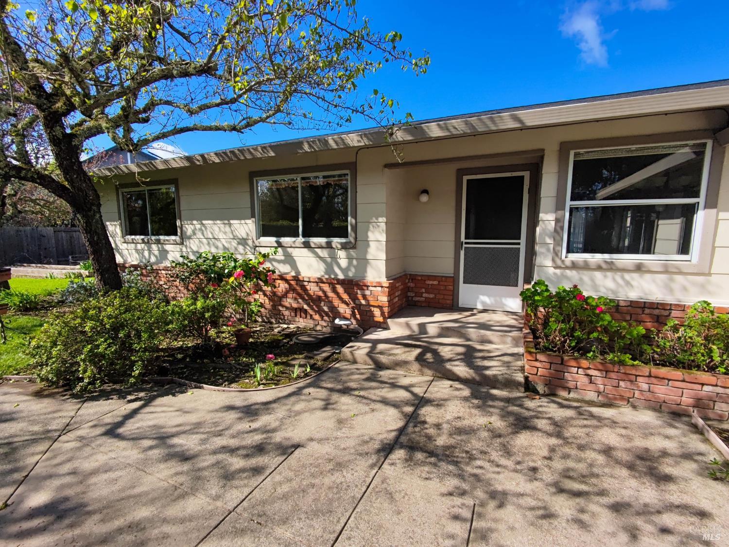 135 Fulton Place Windsor, CA 95492 - Photo 36 of 41 a front view of a house with a yard and potted plants