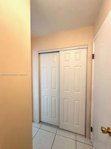 a bed sitting in a bedroom and a night stand