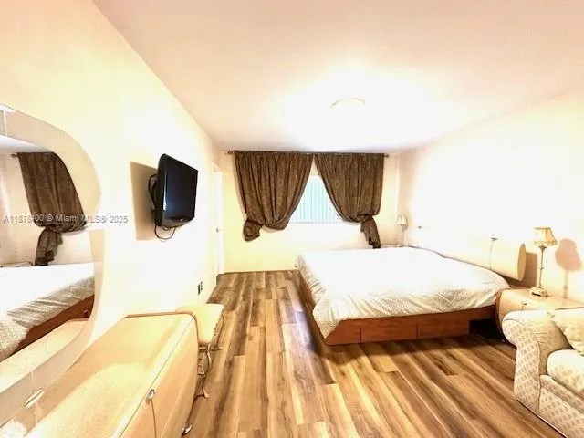 a bedroom with a bed and a couch