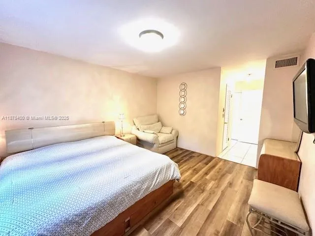 a bedroom with a bed and a mirror