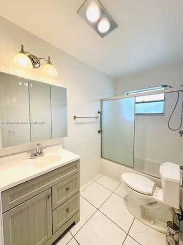 a view of a room with wooden floor and windows