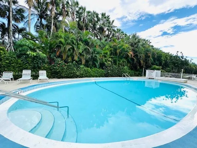 a room with gym equipment and a view of living room