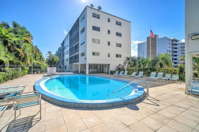 a view of a livingroom with furniture and a window