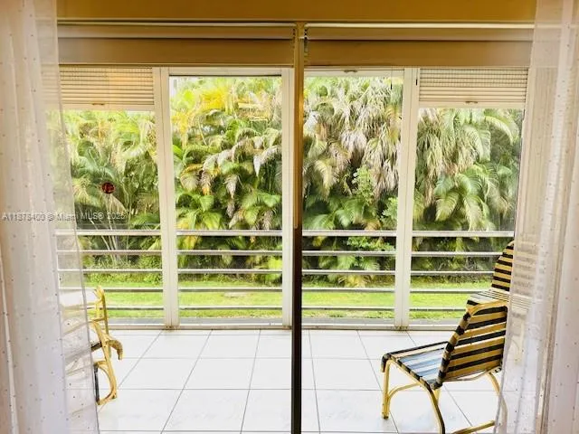 a view of a room with a large window and a chair