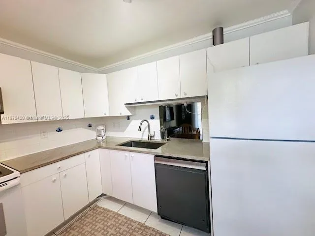 a kitchen with a refrigerator sink and stove