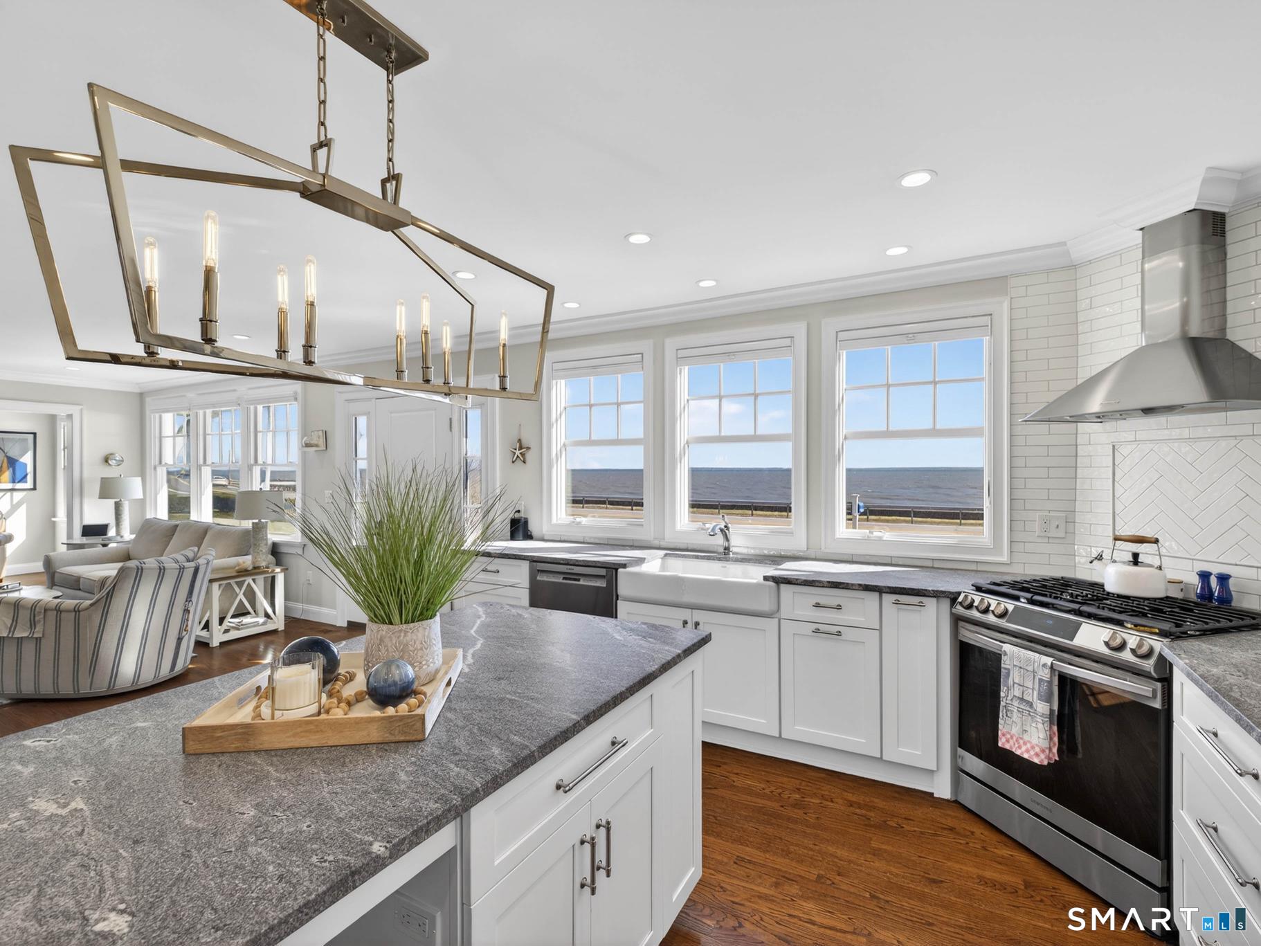 382 Maple Avenue Old Saybrook, CT 06475 - Photo 13 of 42 a kitchen with stainless steel appliances granite countertop a sink a stove and a wooden floors