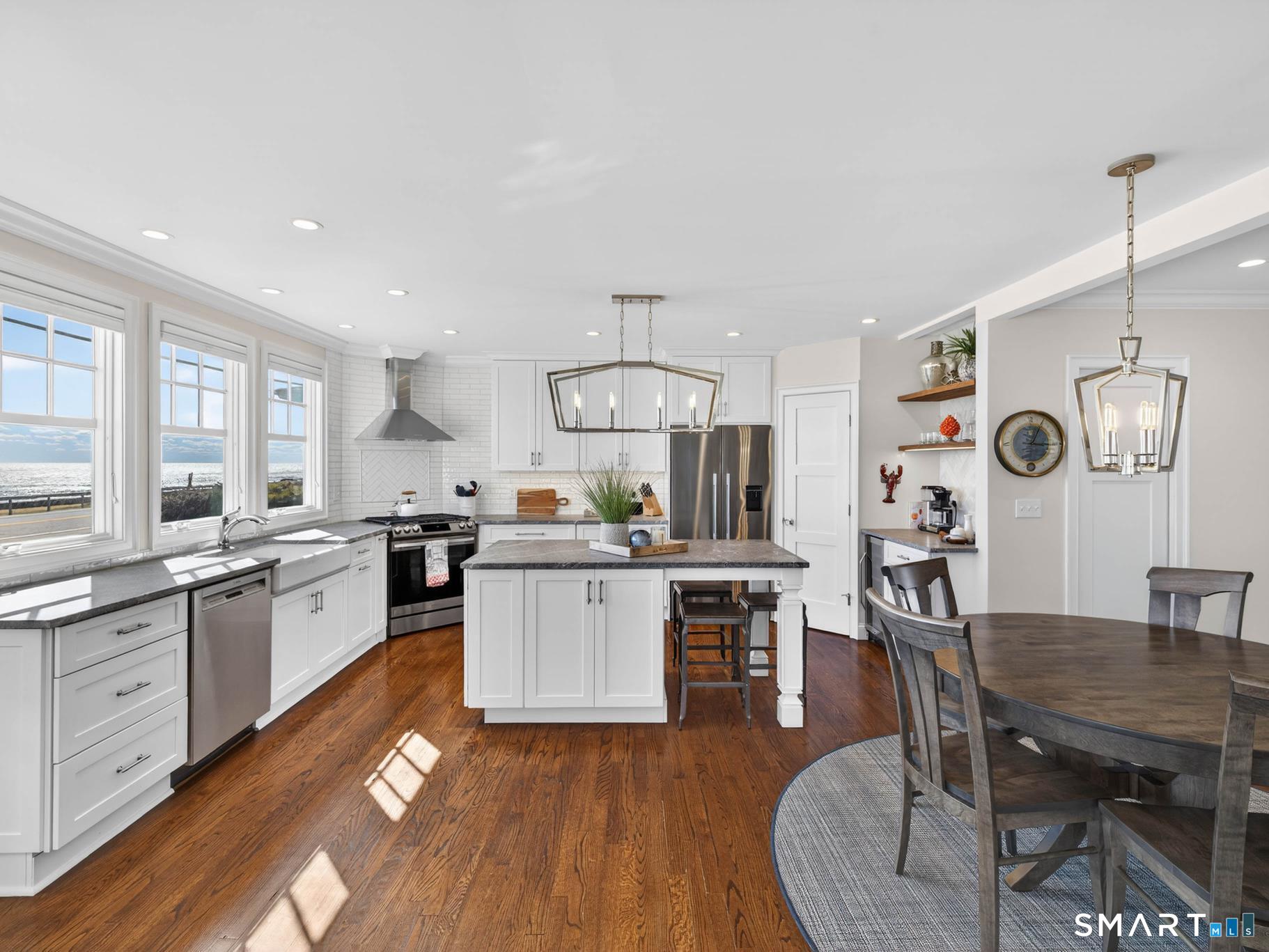 382 Maple Avenue Old Saybrook, CT 06475 - Photo 16 of 42 a kitchen with sink a stove and chairs