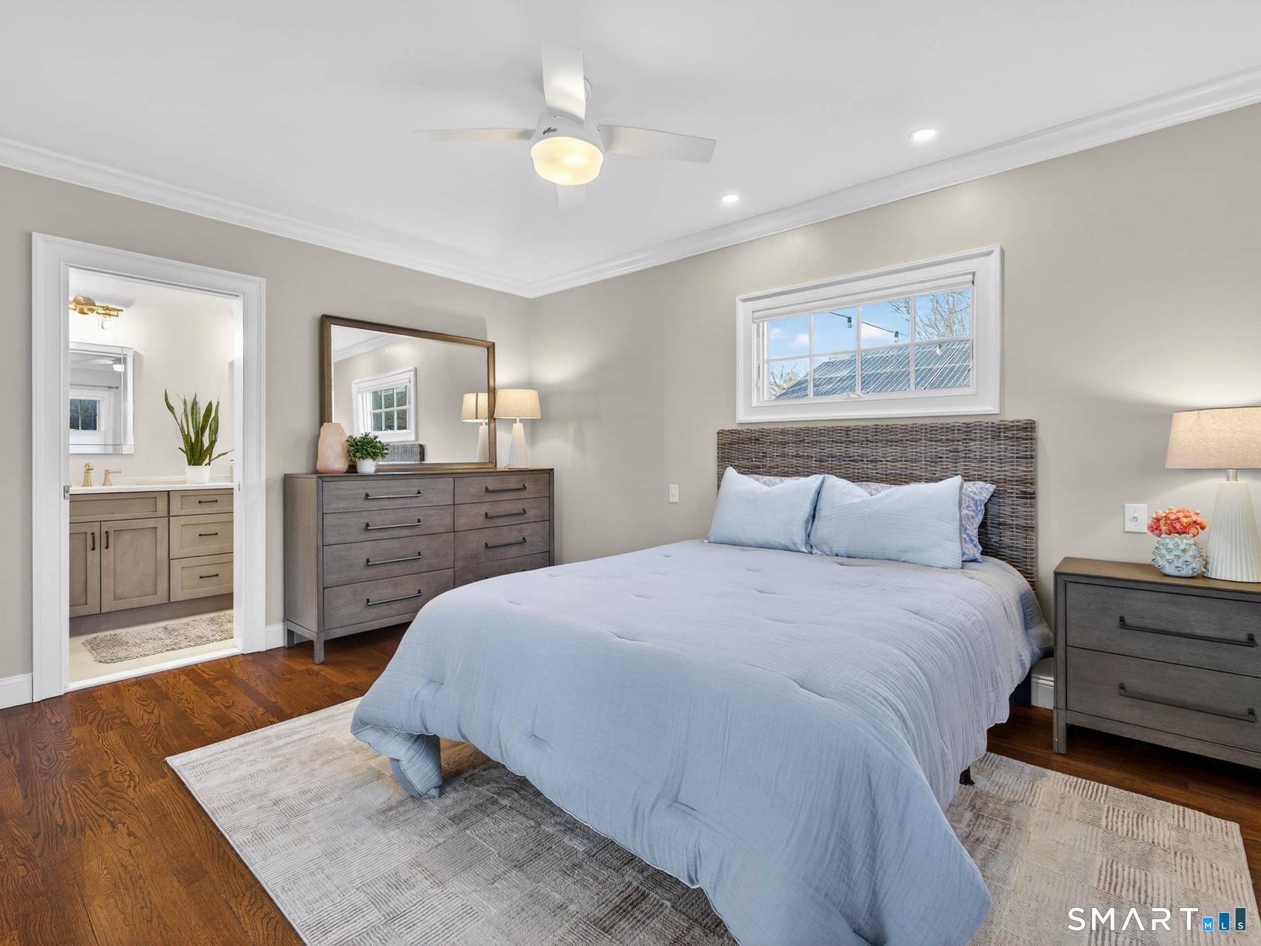 382 Maple Avenue Old Saybrook, CT 06475 - Photo 18 of 42 a bedroom with a large bed and a chandelier
