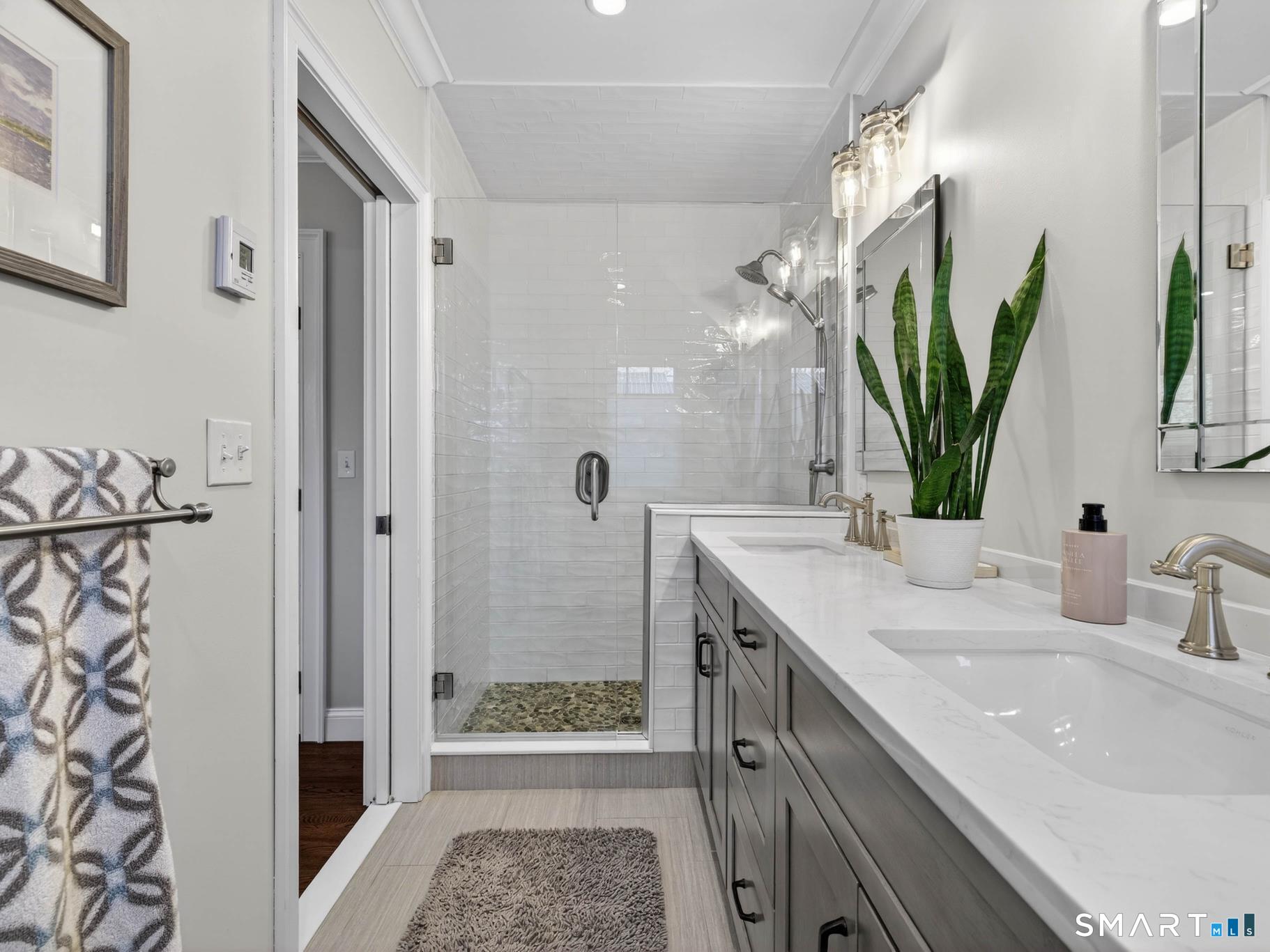 382 Maple Avenue Old Saybrook, CT 06475 - Photo 20 of 42 a bathroom with a double vanity sink and a mirror
