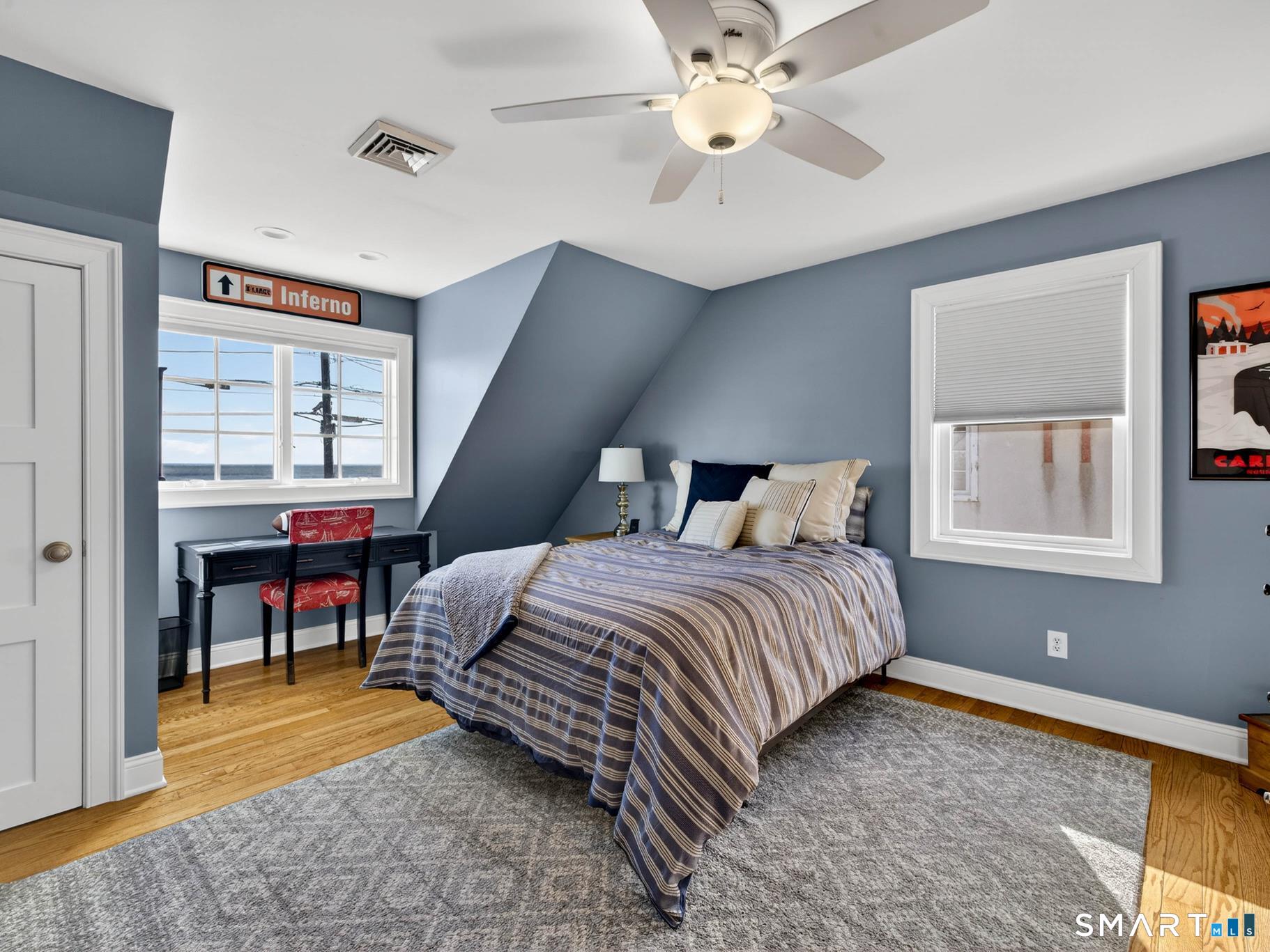 382 Maple Avenue Old Saybrook, CT 06475 - Photo 24 of 42 a bedroom with a bed and a chandelier