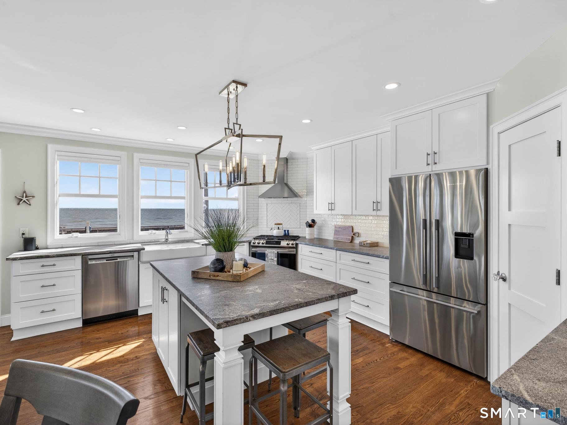 382 Maple Avenue Old Saybrook, CT 06475 - Photo 5 of 42 a kitchen with granite countertop stainless steel appliances a sink a stove a refrigerator cabinets and dining table