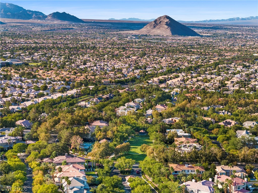 2000 Grouse Street Las Vegas, NV 89134 - Photo 77 of 89 An aerial perspective reveals a vast residential community nestled against a majestic mountain backdrop.