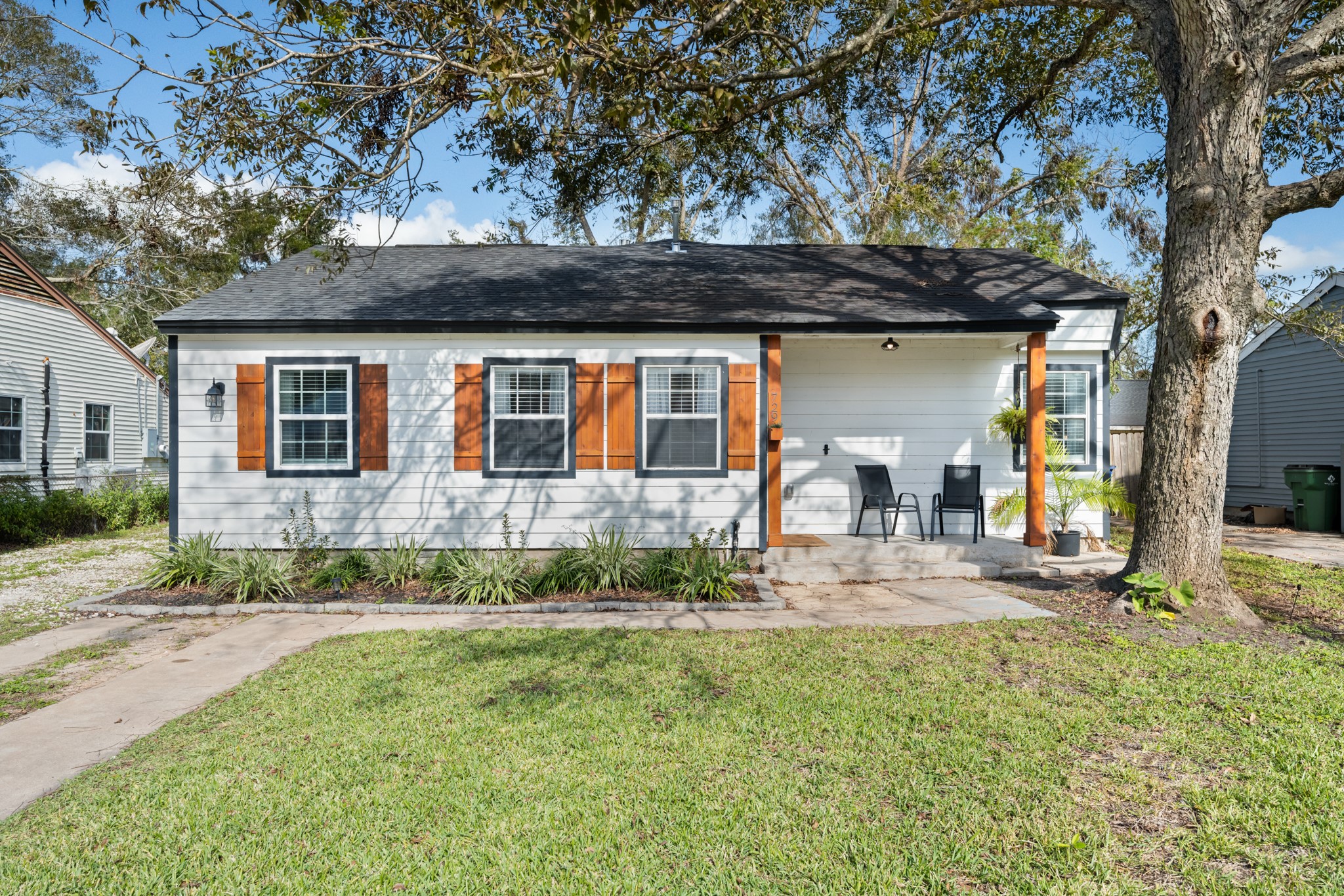 729 Kyle Angleton, TX 77515 - Photo 1 of 36 Charming single-story home featuring fresh white siding accented by natural wood shutters and trim. Mature trees and simple landscaping create inviting curb appeal with a welcoming walkway leading to the covered front porch.