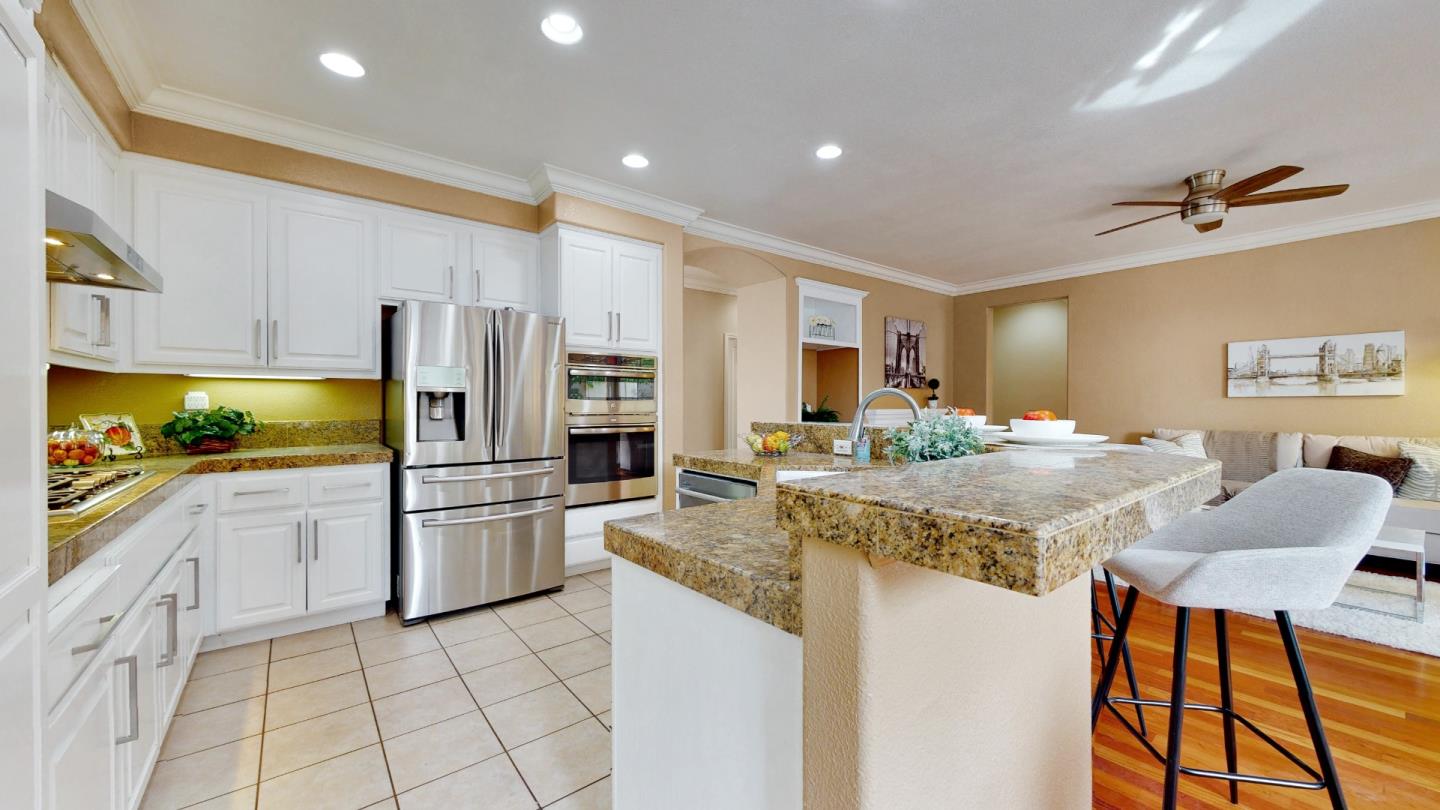 348 Riesling Court Fremont, CA 94539 - Photo 7 of 19 a kitchen with stainless steel appliances granite countertop a sink refrigerator and cabinets