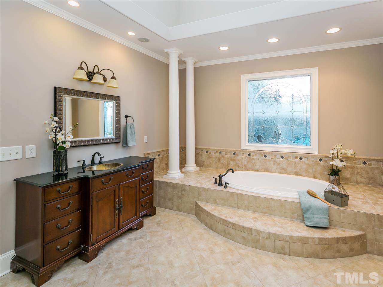 12225 Beestone Lane Raleigh, NC 27614 - Photo 11 of 25 a spacious bathroom with a tub sink and mirror