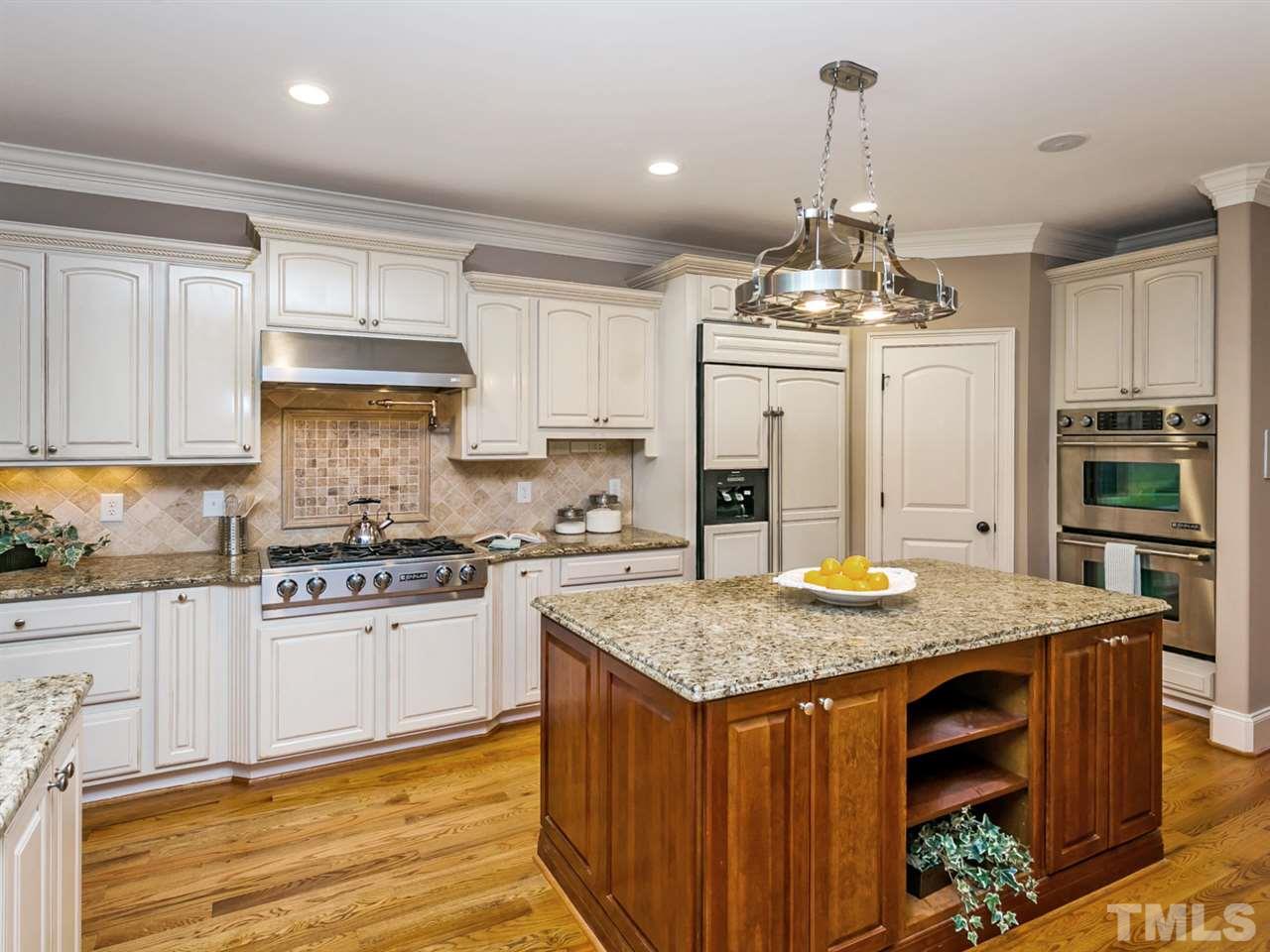 12225 Beestone Lane Raleigh, NC 27614 - Photo 5 of 25 a kitchen with stainless steel appliances granite countertop a stove oven and a refrigerator