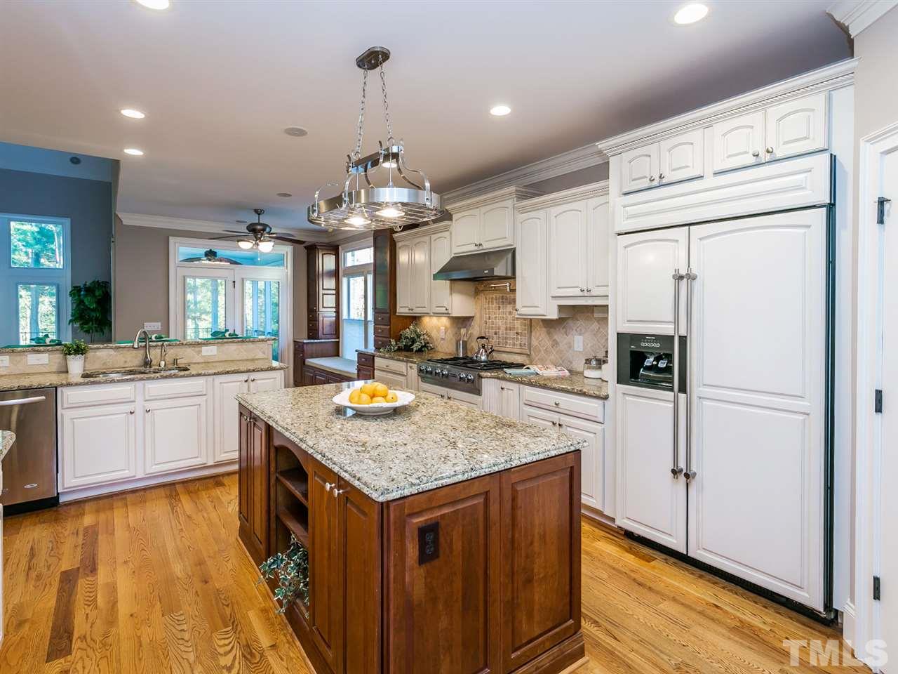 12225 Beestone Lane Raleigh, NC 27614 - Photo 7 of 25 a kitchen with stainless steel appliances granite countertop a sink stove and refrigerator
